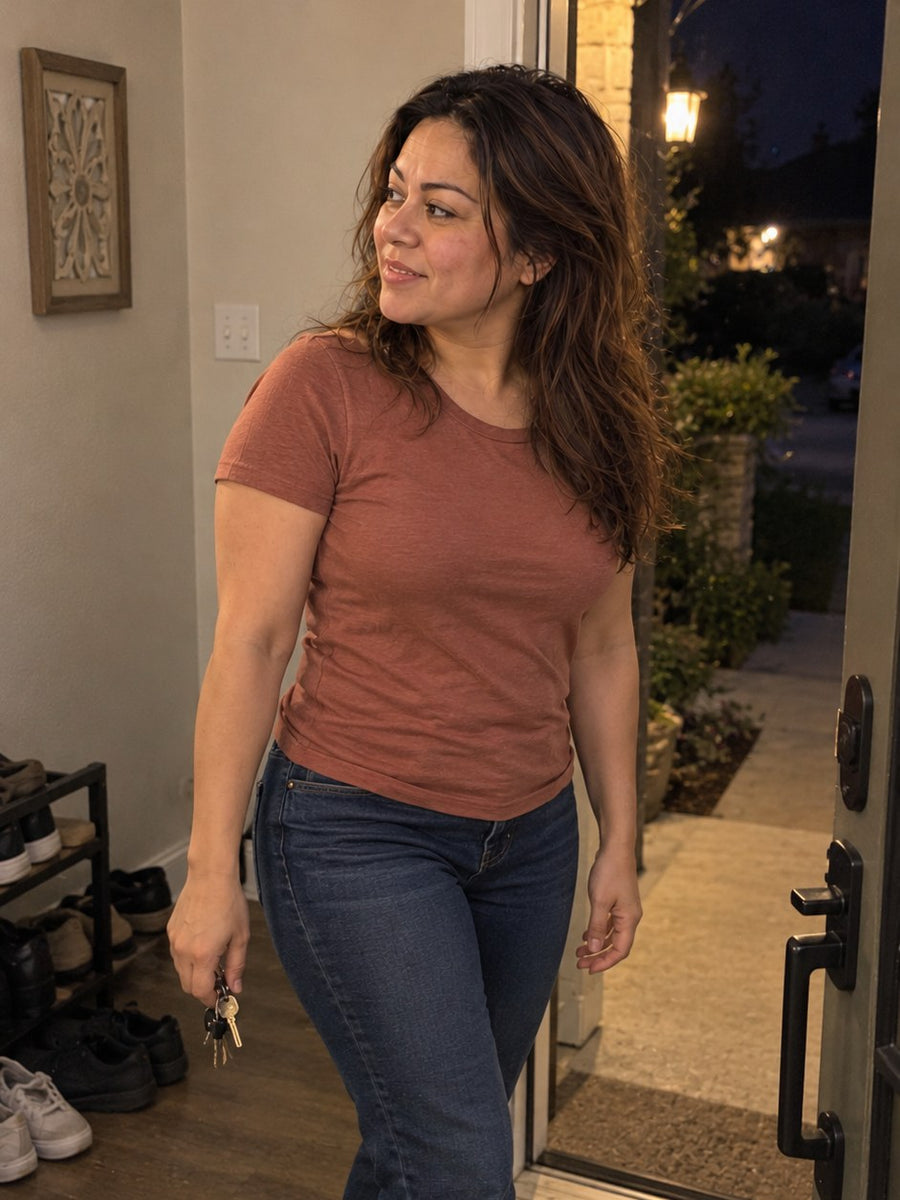 The same woman heading out the front door in the evening