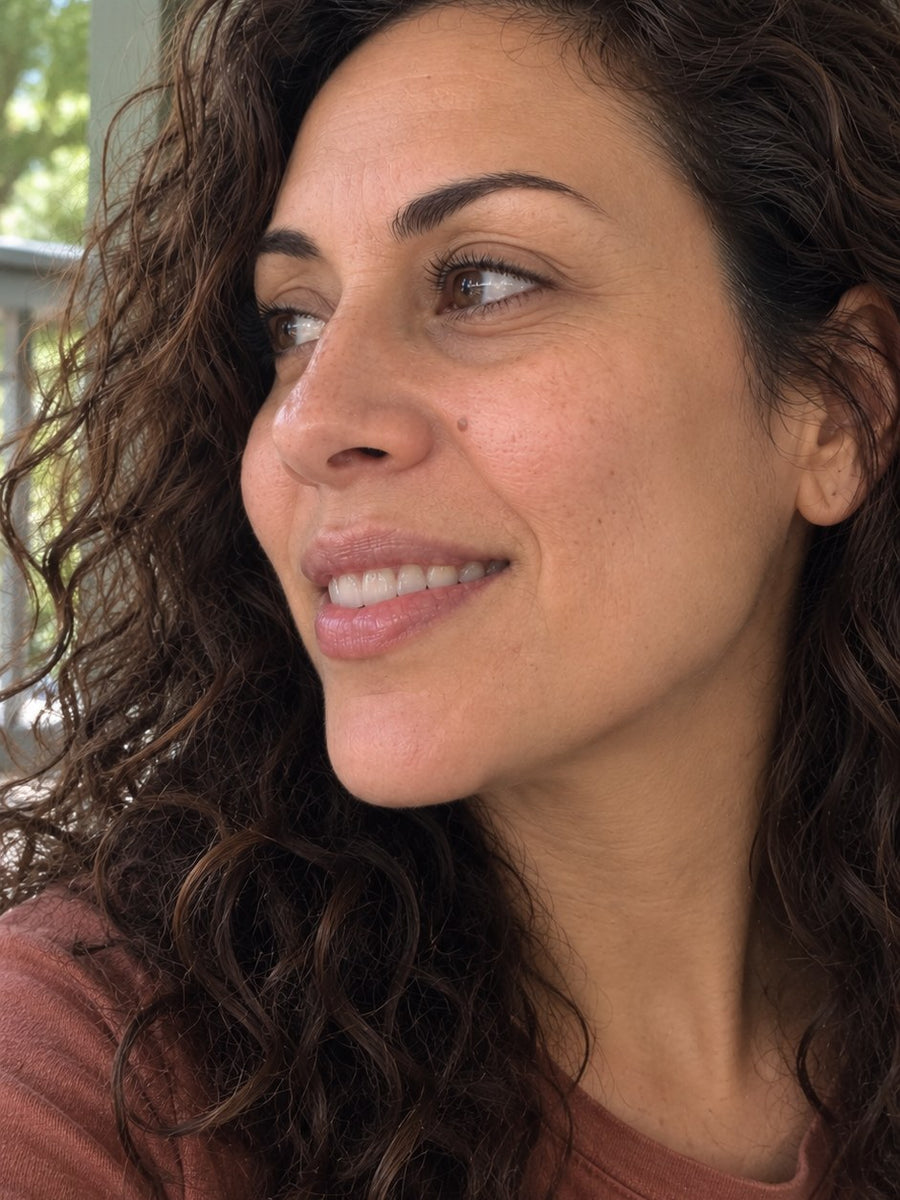 The same woman smiling, skin looking smoother