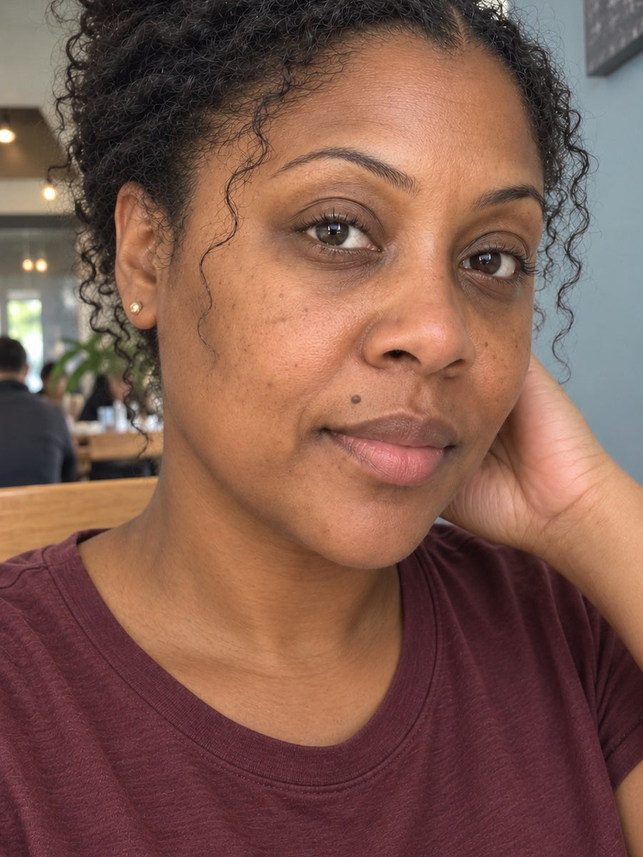 The same woman at a café, looking rested with a brighter, even tone